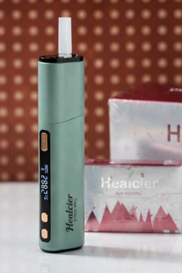 Healcier vape pen and packaging on a white surface with a patterned wall background